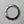 Silver watch bezel with numerical markings on a gray background