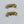 Two gold metal components on a white background